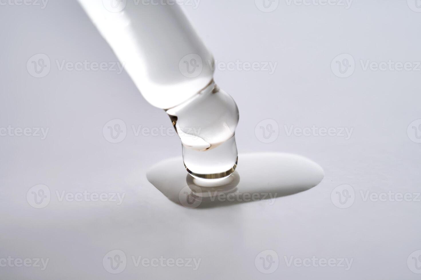 Dropper pipette with delicious serum with drop close-up. photo
