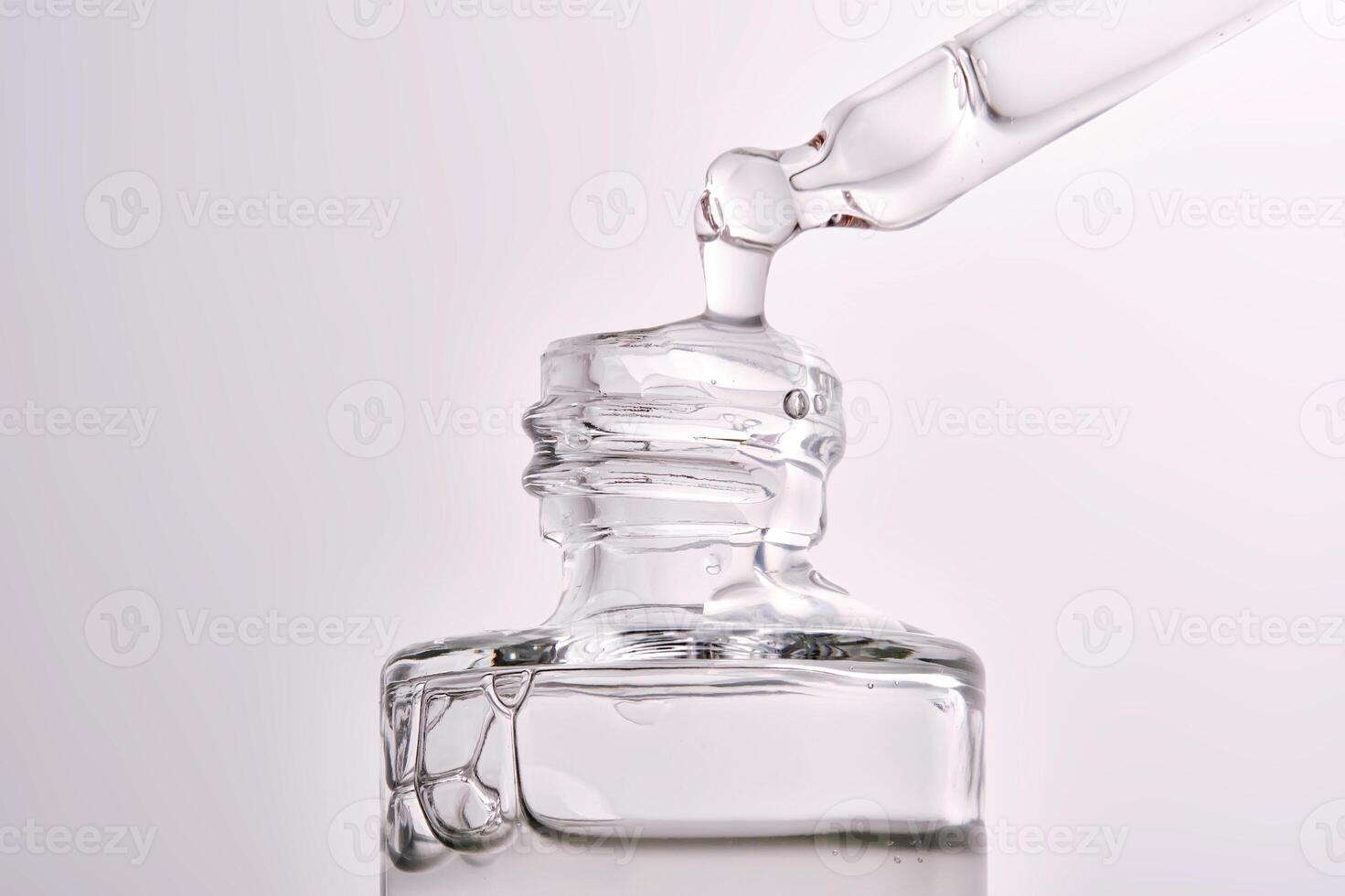 Close-up of a cosmetic bottle with a pipette showing the texture of the serum. photo