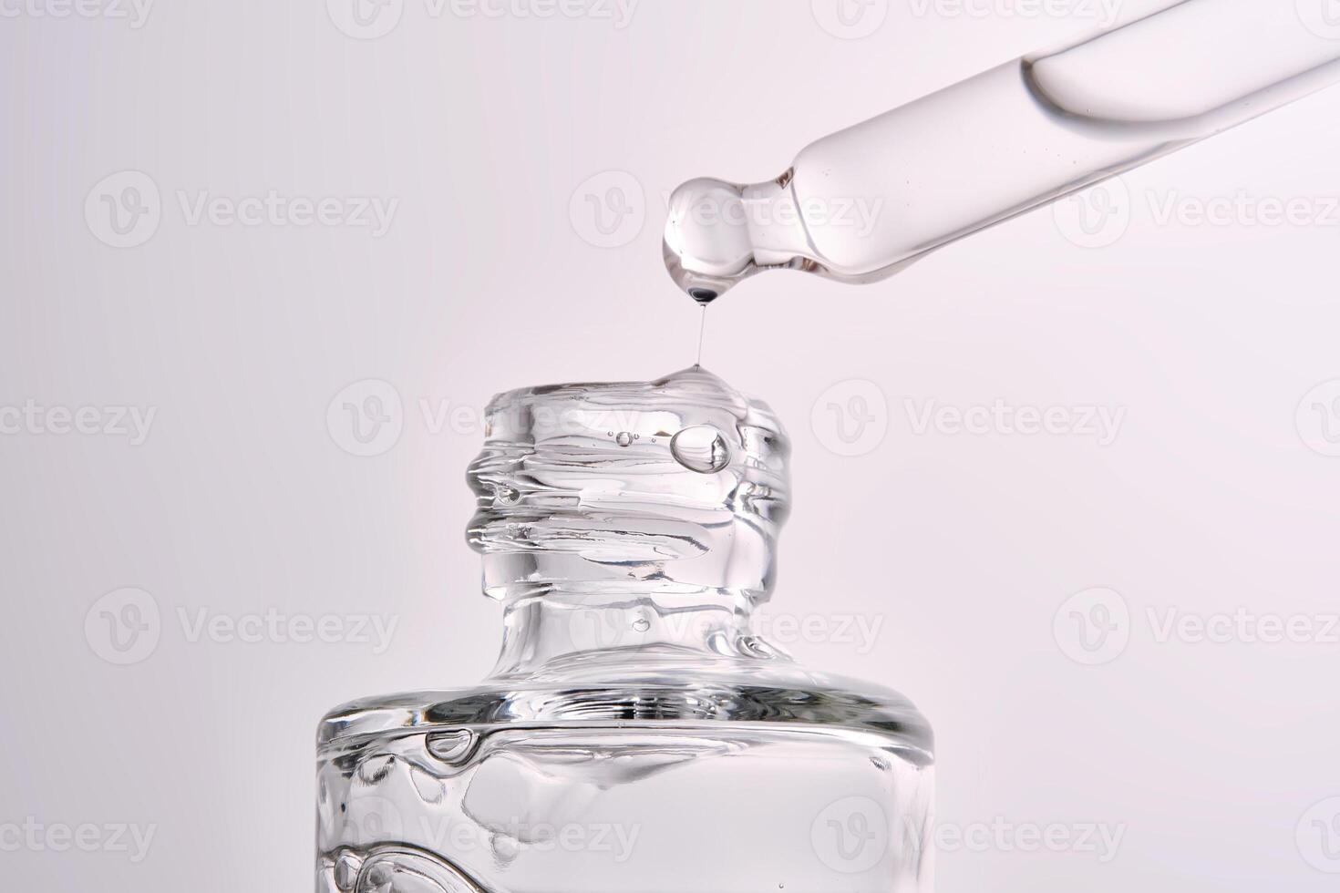 Close-up of a cosmetic bottle with a pipette showing the texture of the serum. photo