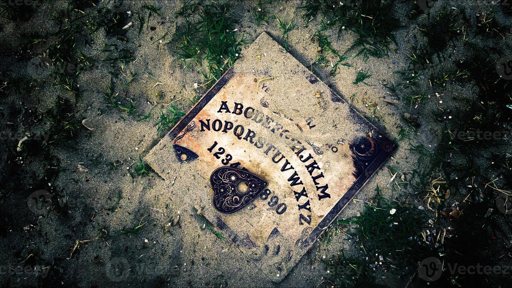 Witchcraft Spiritual Halloween Game Ouija Board on Soil and Grass Ground photo