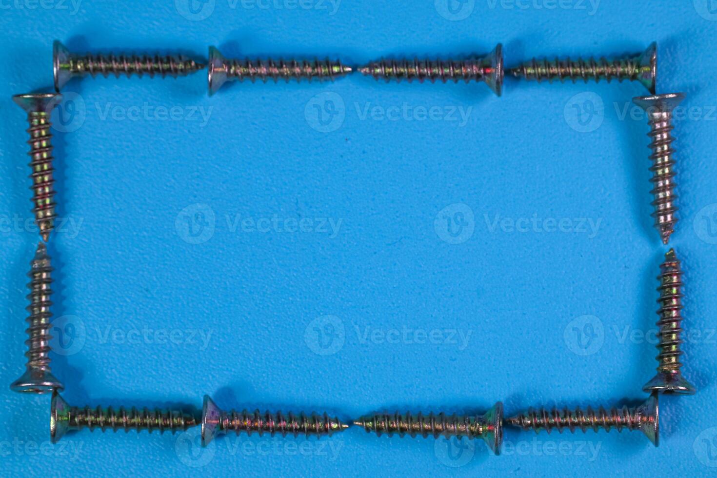 group of screws forming a frame isolated on a blue background photo