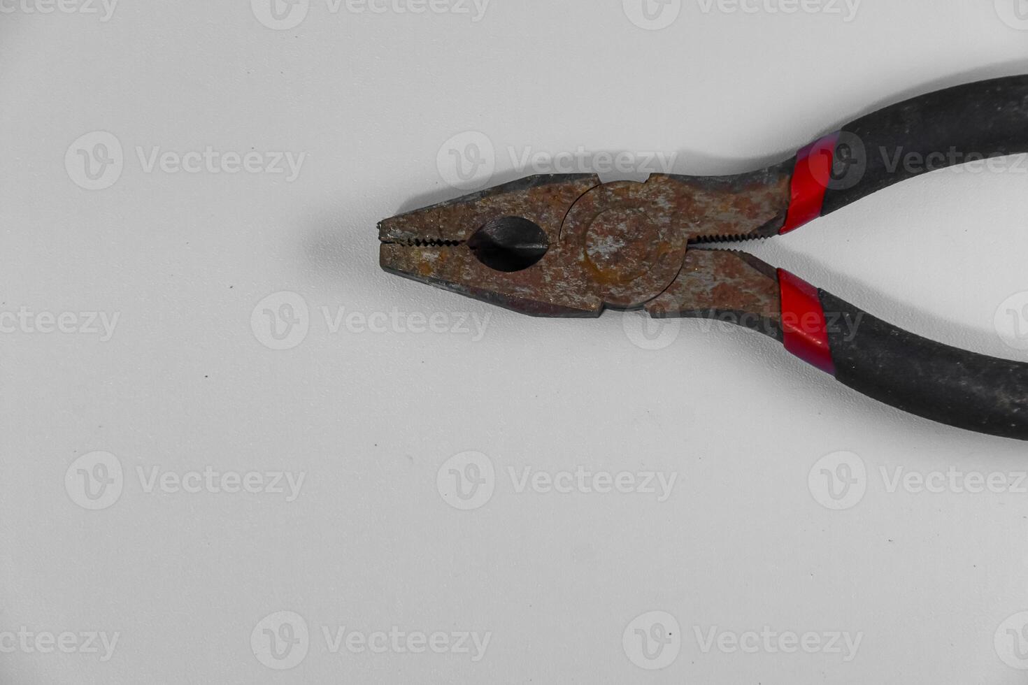 rusty pliers isolated on white background photo