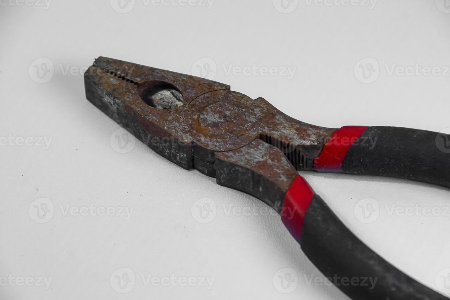 rusty pliers isolated on white background photo