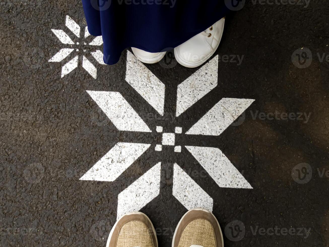 top view of a pair of men's and women's shoes among octagonal shapes photo