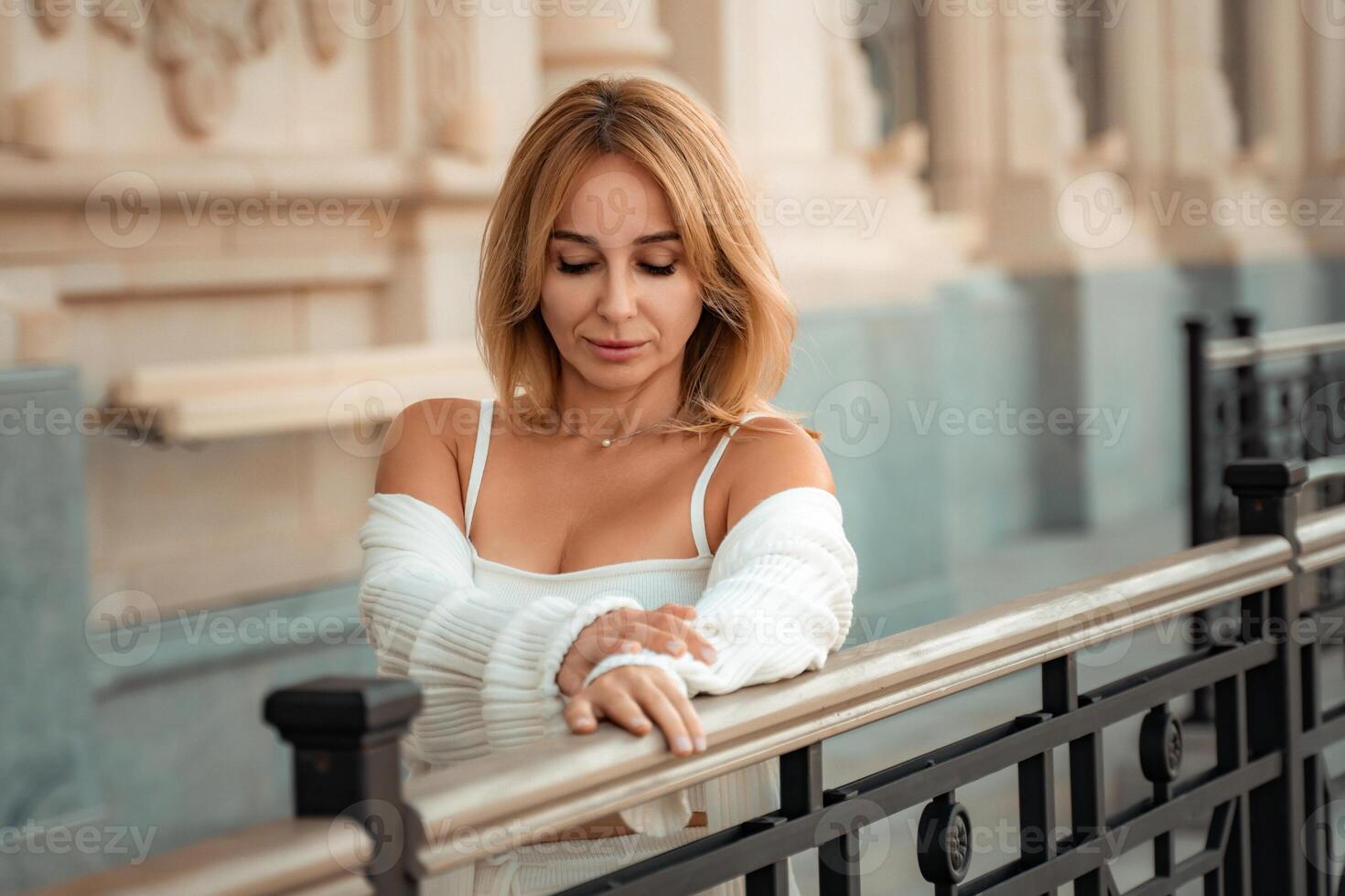 Woman, White, Fence. Portrait of a woman in white clothing leaning on a railing. photo