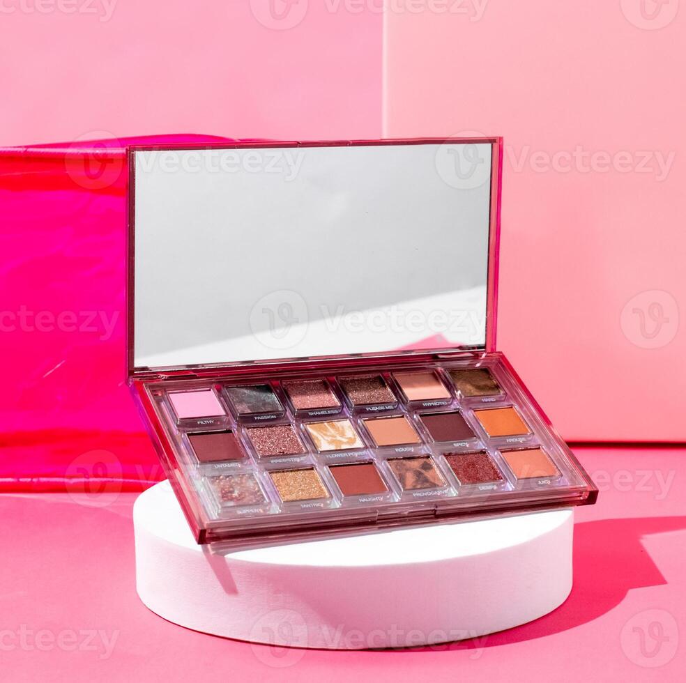 A pink box with a makeup palette and a mirror photo
