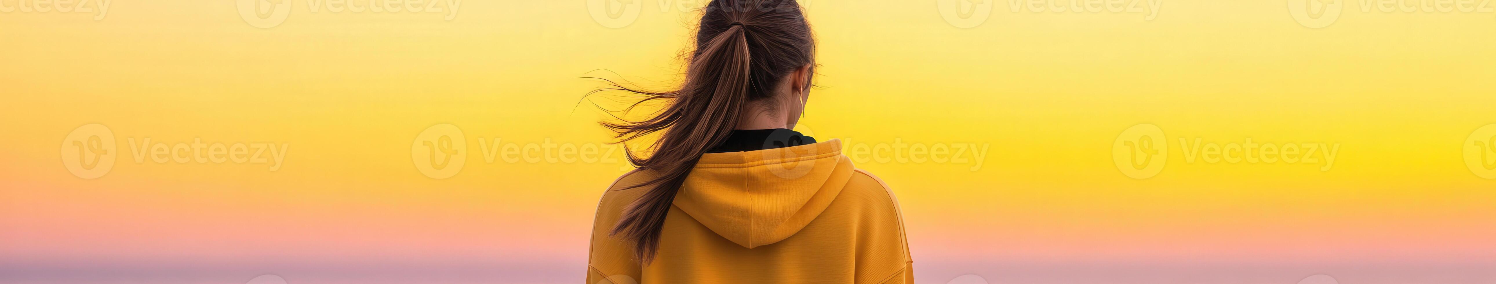 Person admires sunset while standing on shore with vibrant sky colors photo