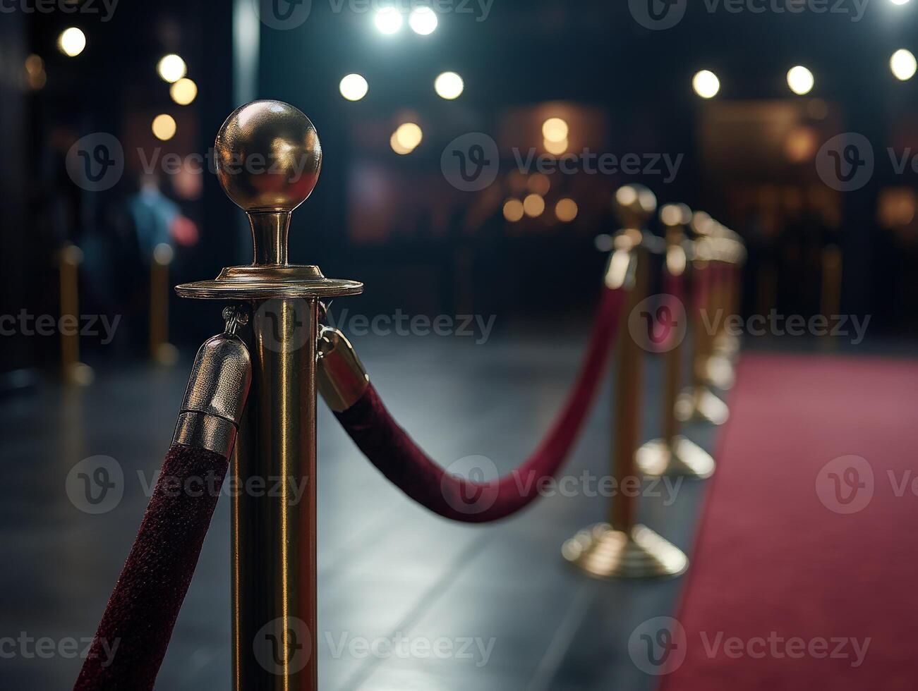 Elegant red carpet setup with velvet ropes and golden stanchions at night photo