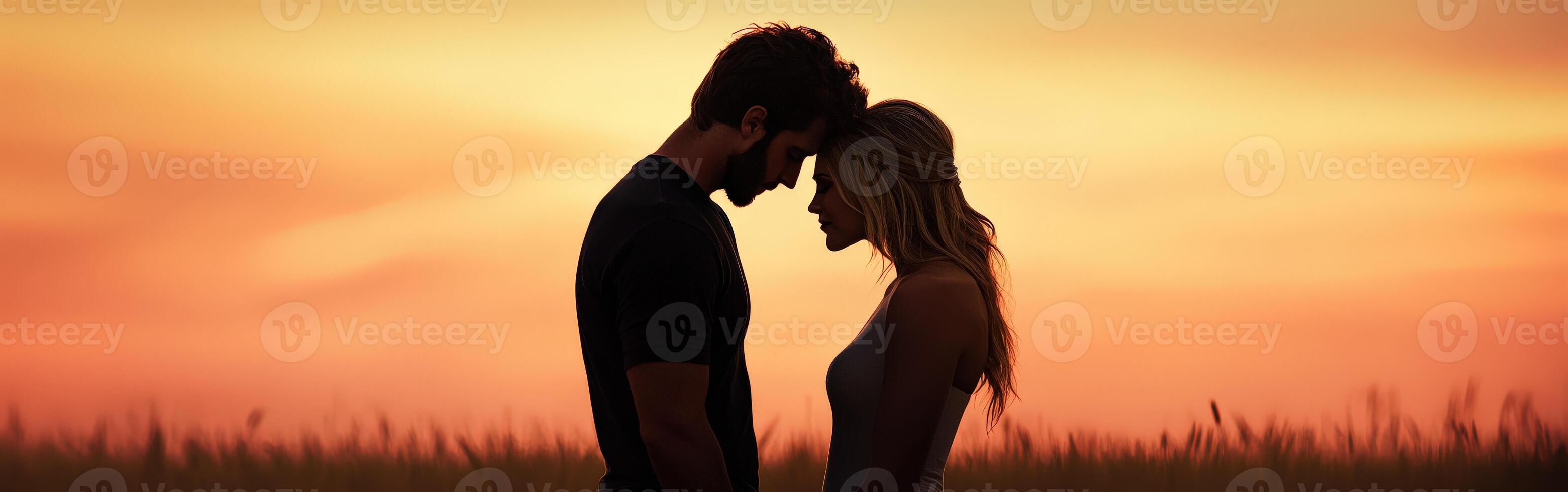Couple embracing at sunset in a serene open field photo