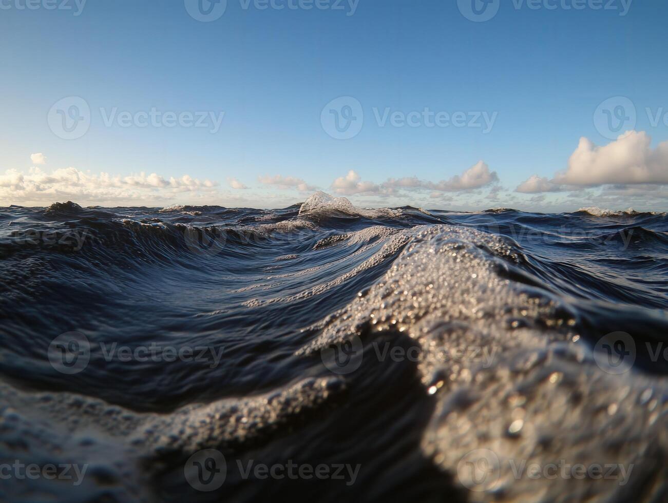 Waves gently rolling in under a clear blue sky at dusk photo