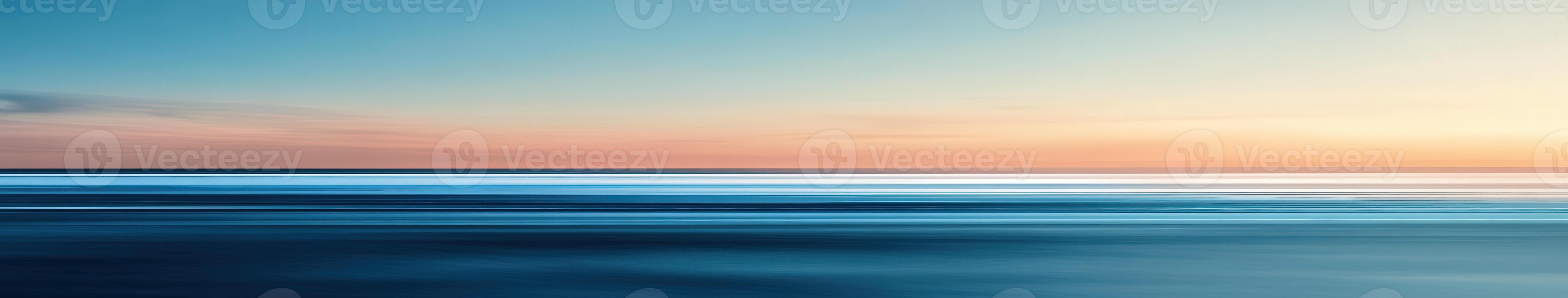 Tranquil sunset over the calm ocean waters at twilight photo