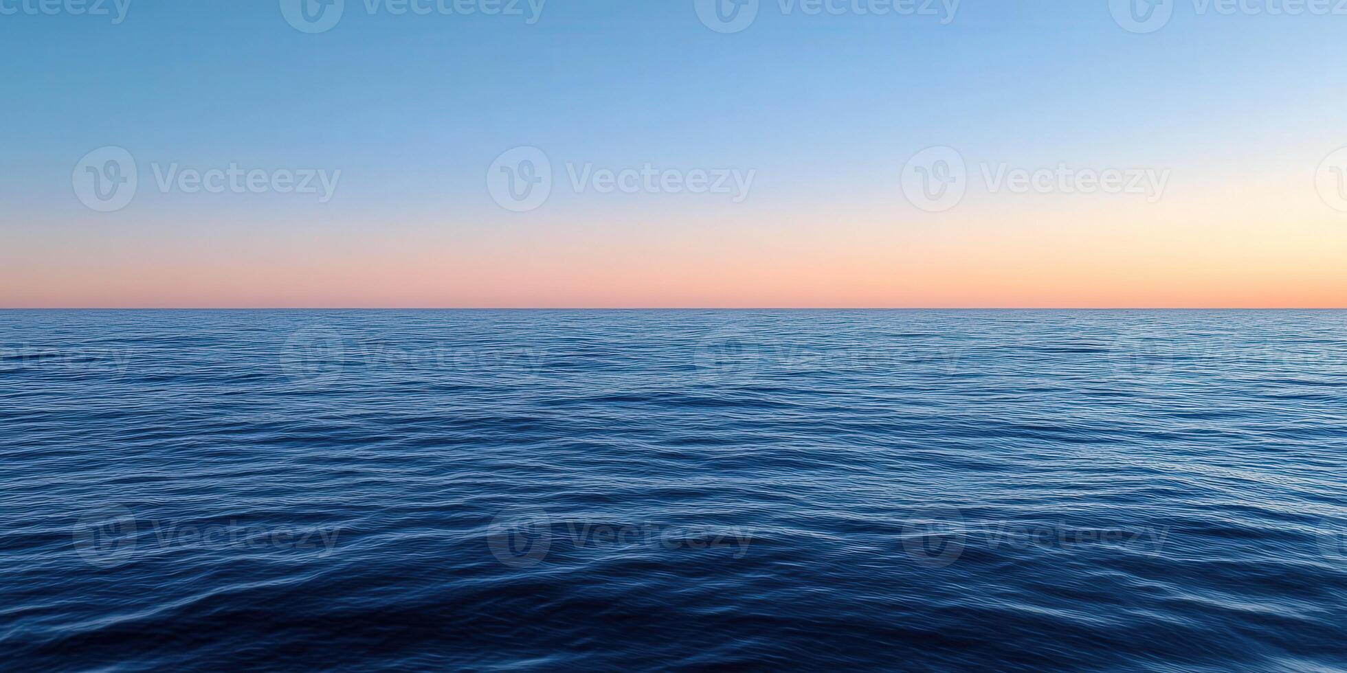 Calming blue ocean waves under a pastel sunset sky at dusk photo