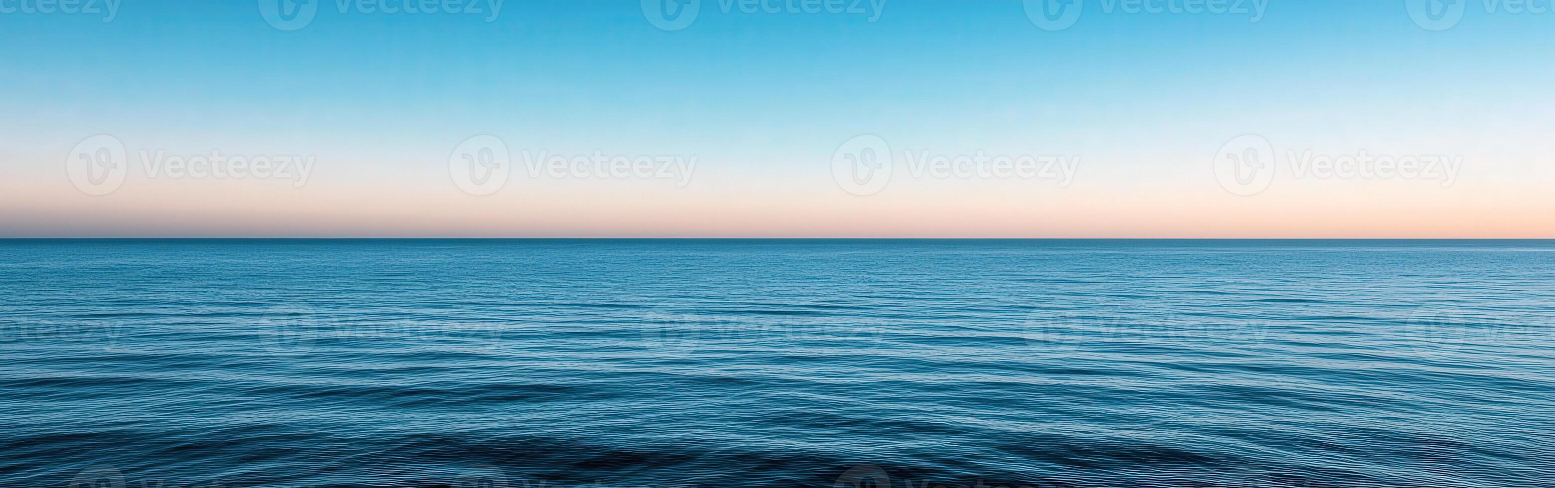 Calm ocean view at sunset with gentle waves and colorful sky photo