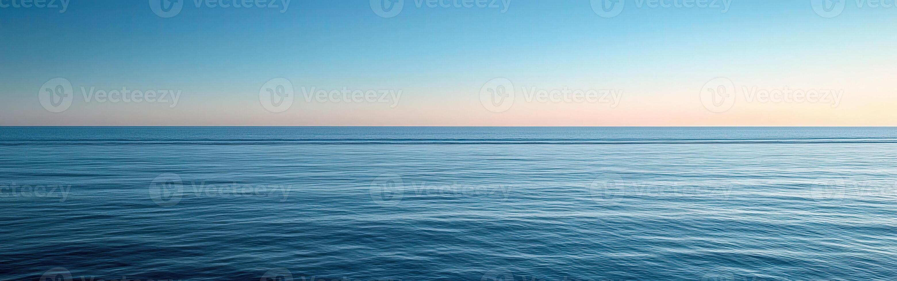 Calm ocean horizon at dusk with gentle waves and clear sky photo