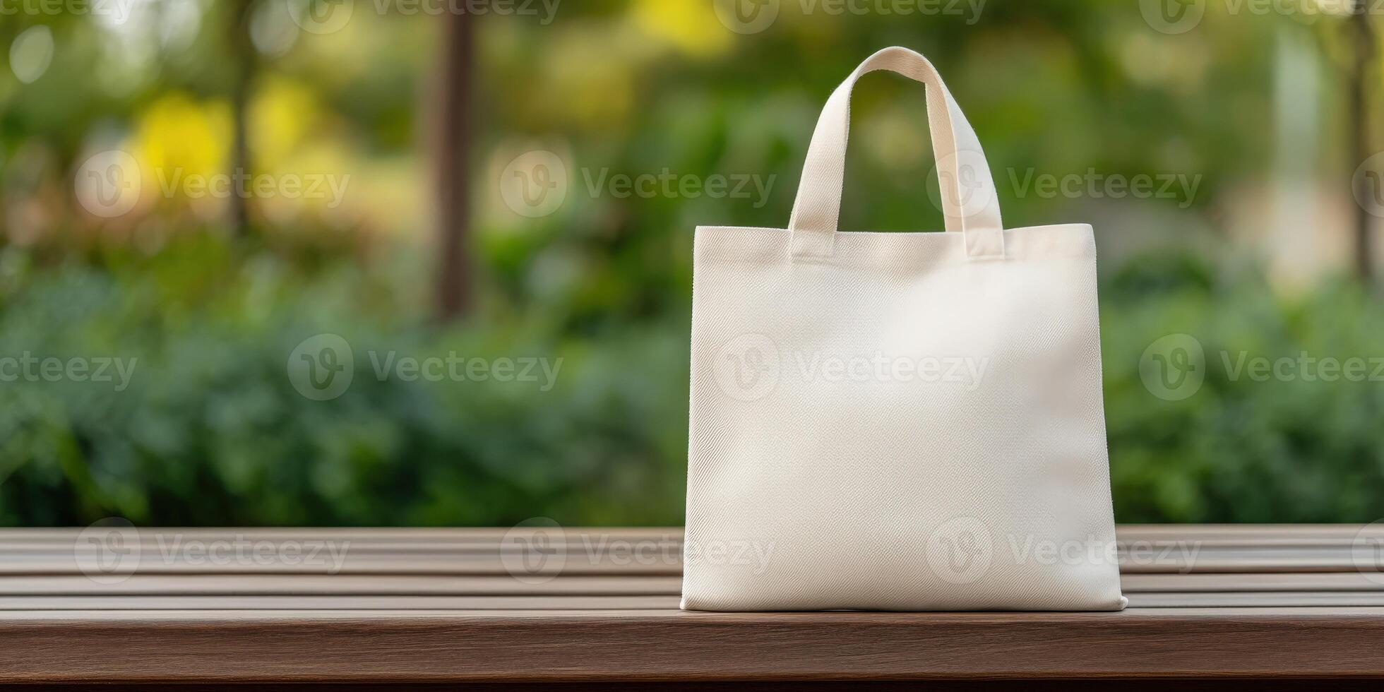 Simple white tote bag resting on a wooden table in a park photo