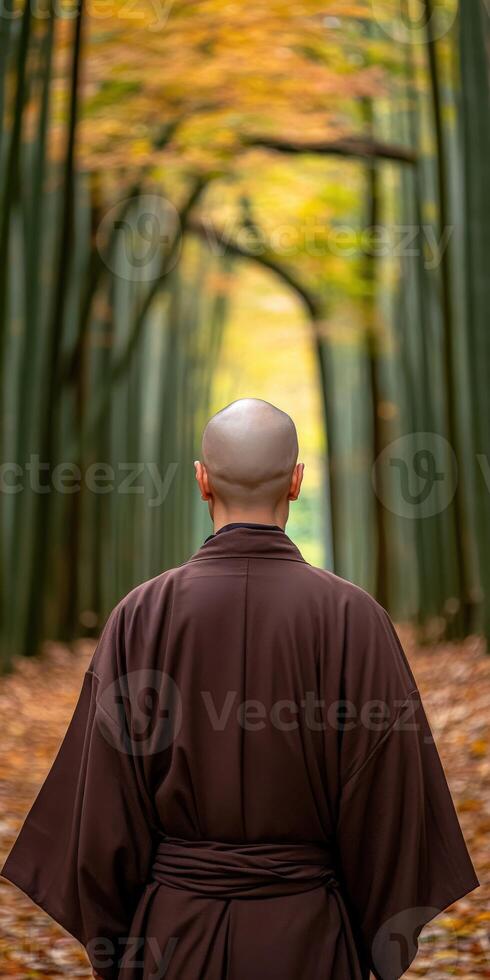 Monk walking through a serene bamboo forest in autumn photo