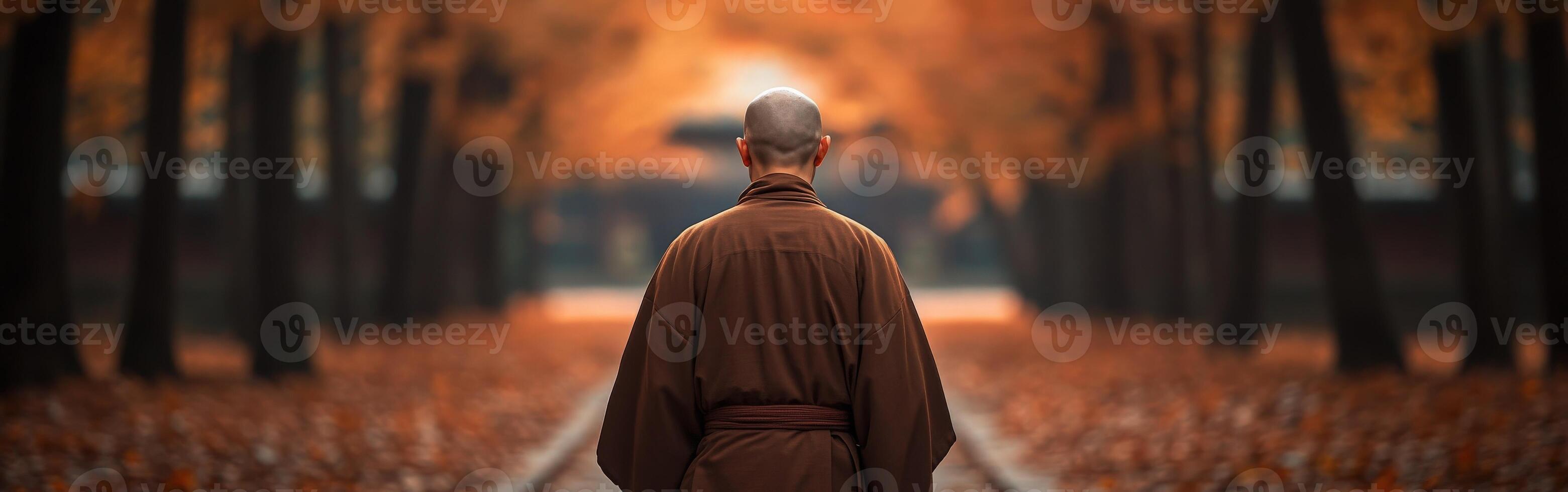 A monk walking through a tranquil autumn forest at sunset photo