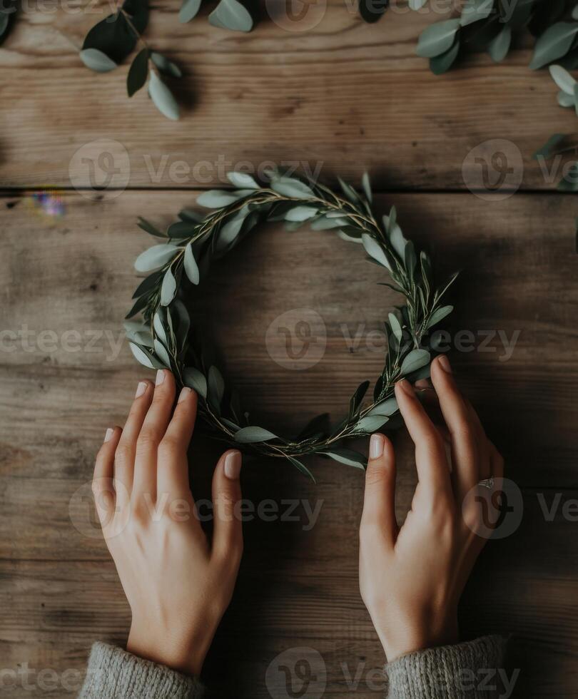 Creating a simple greenery wreath on a rustic wooden table photo
