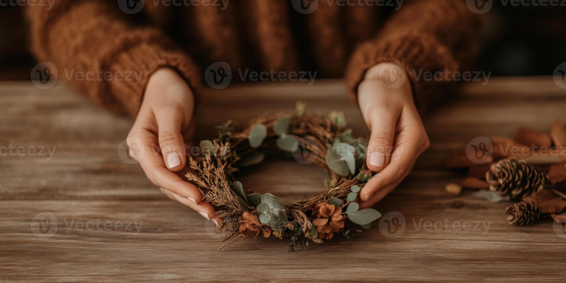 Creating a seasonal wreath with natural elements at a crafting table photo
