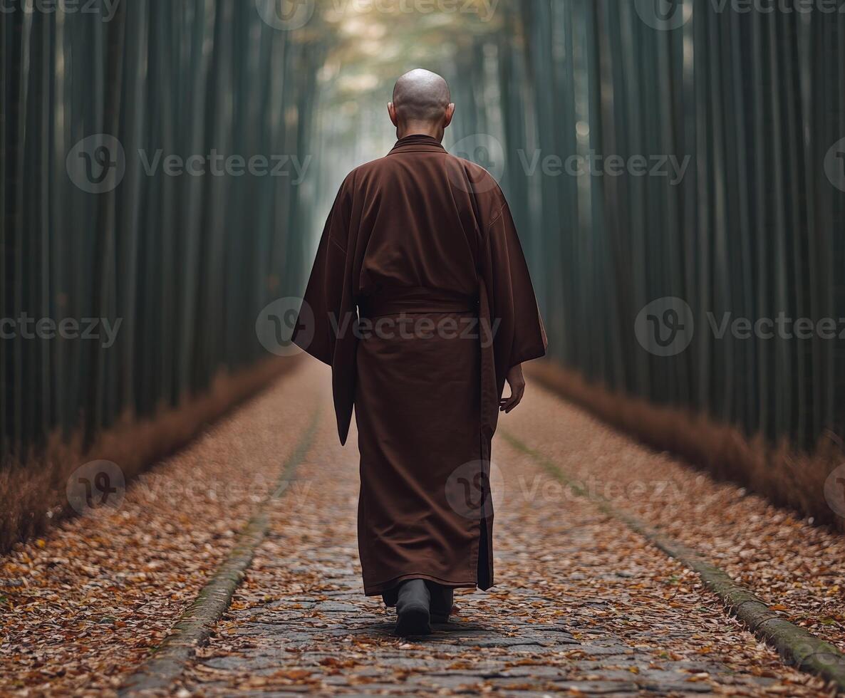 A monk walking through a serene bamboo forest on a quiet autumn day photo