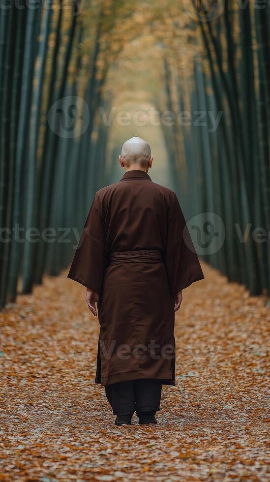 A monk walking through a serene bamboo grove during autumn photo