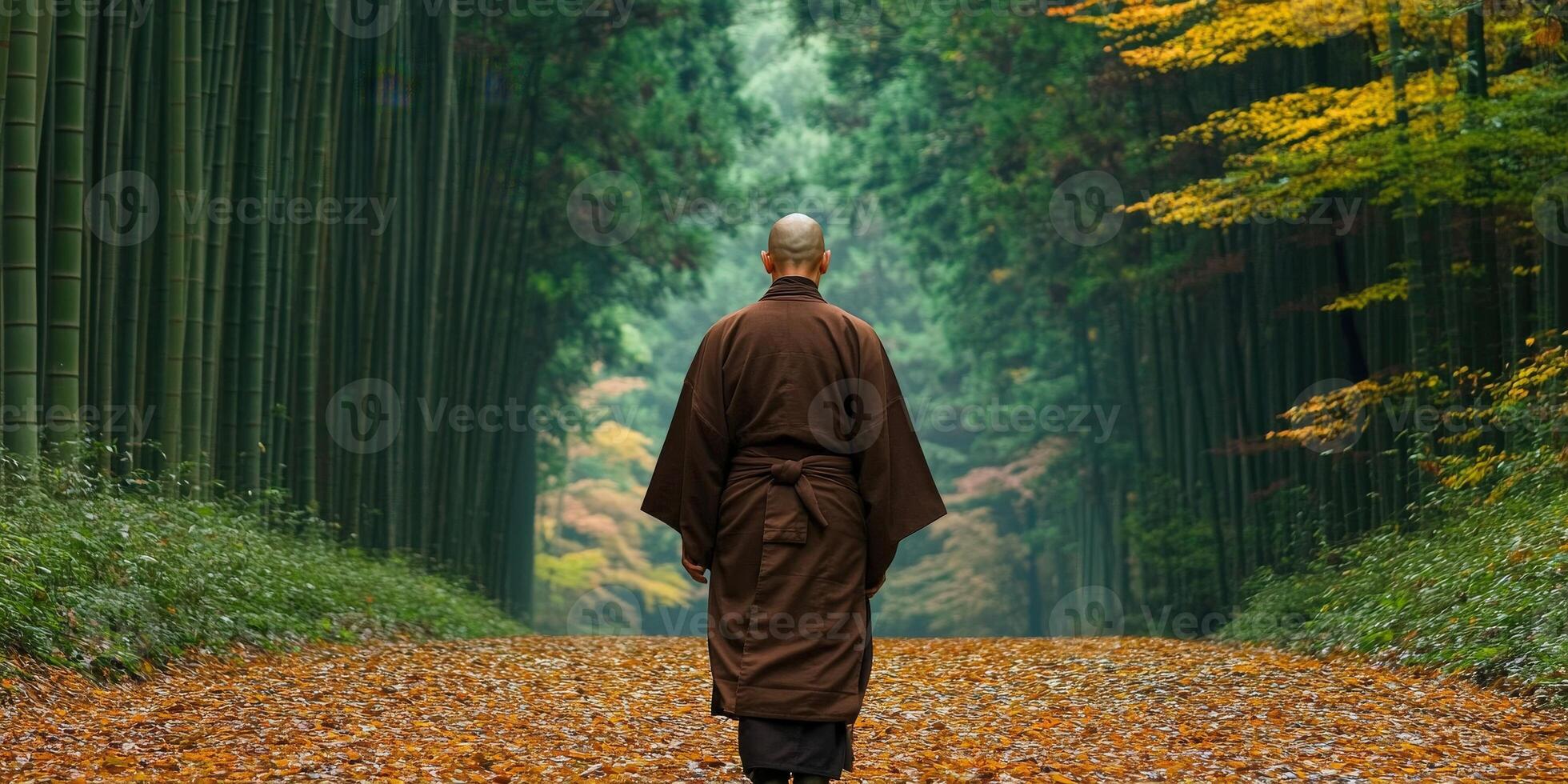 A monk walking through a tranquil bamboo forest in autumn photo