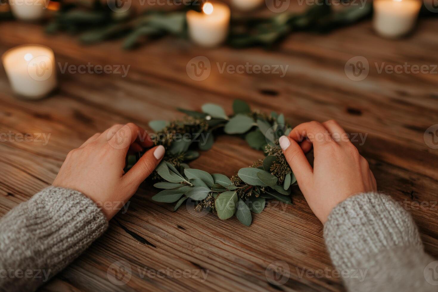 Creating a natural garnished wreath with candles on a wooden table photo