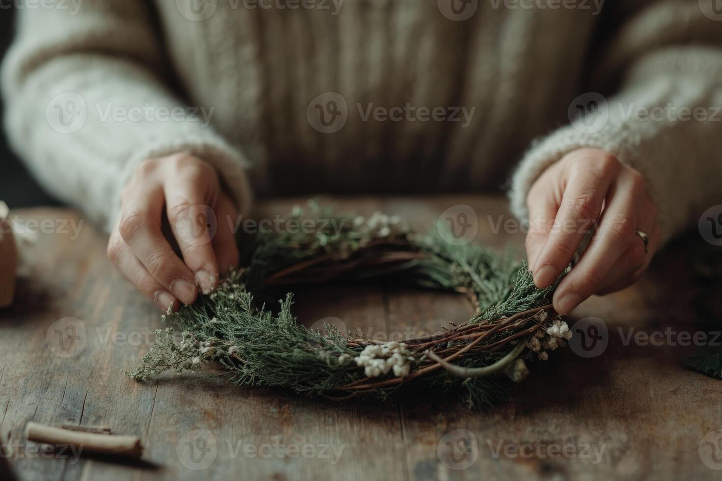 Making a seasonal wreath with greenery and delicate flowers at home photo