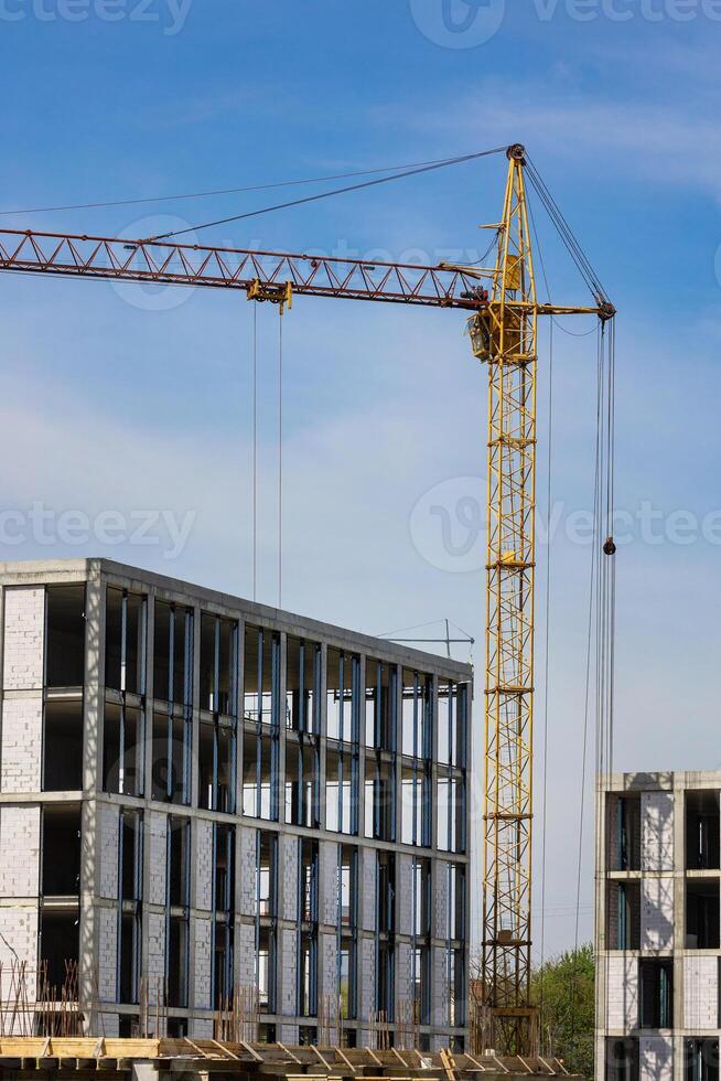 construction crane building real estate against a blue sky background photo