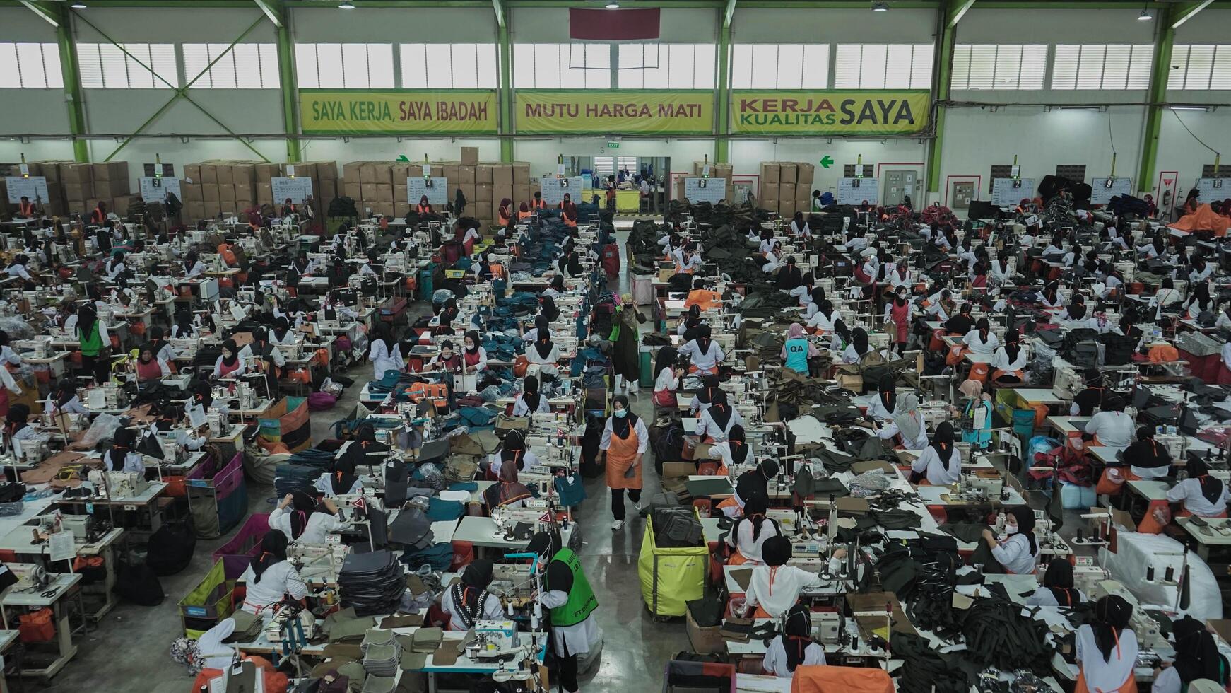 Asian textile sewing factory with many workers, Indonesia. photo