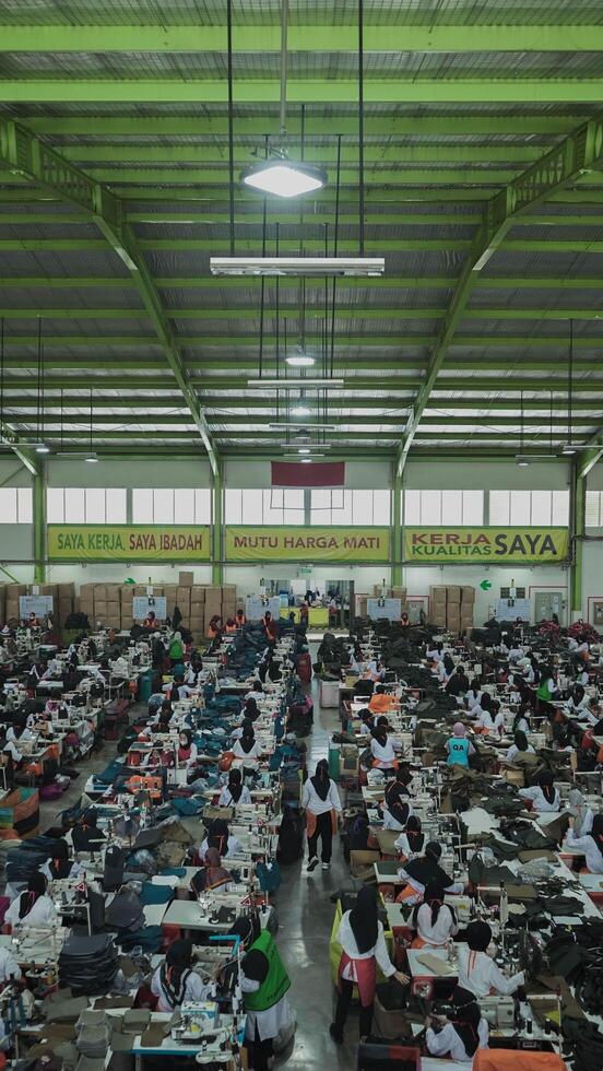 Asian textile sewing factory with many workers, Indonesia. photo