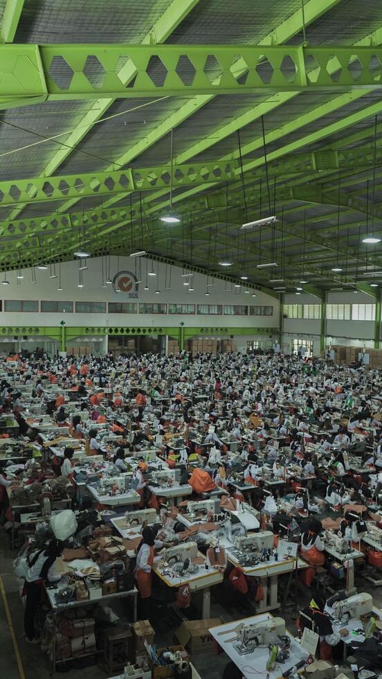 Asian textile sewing factory with many workers, Indonesia. photo
