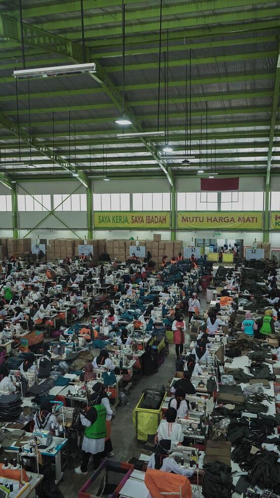 Asian textile sewing factory with many workers, Indonesia. photo