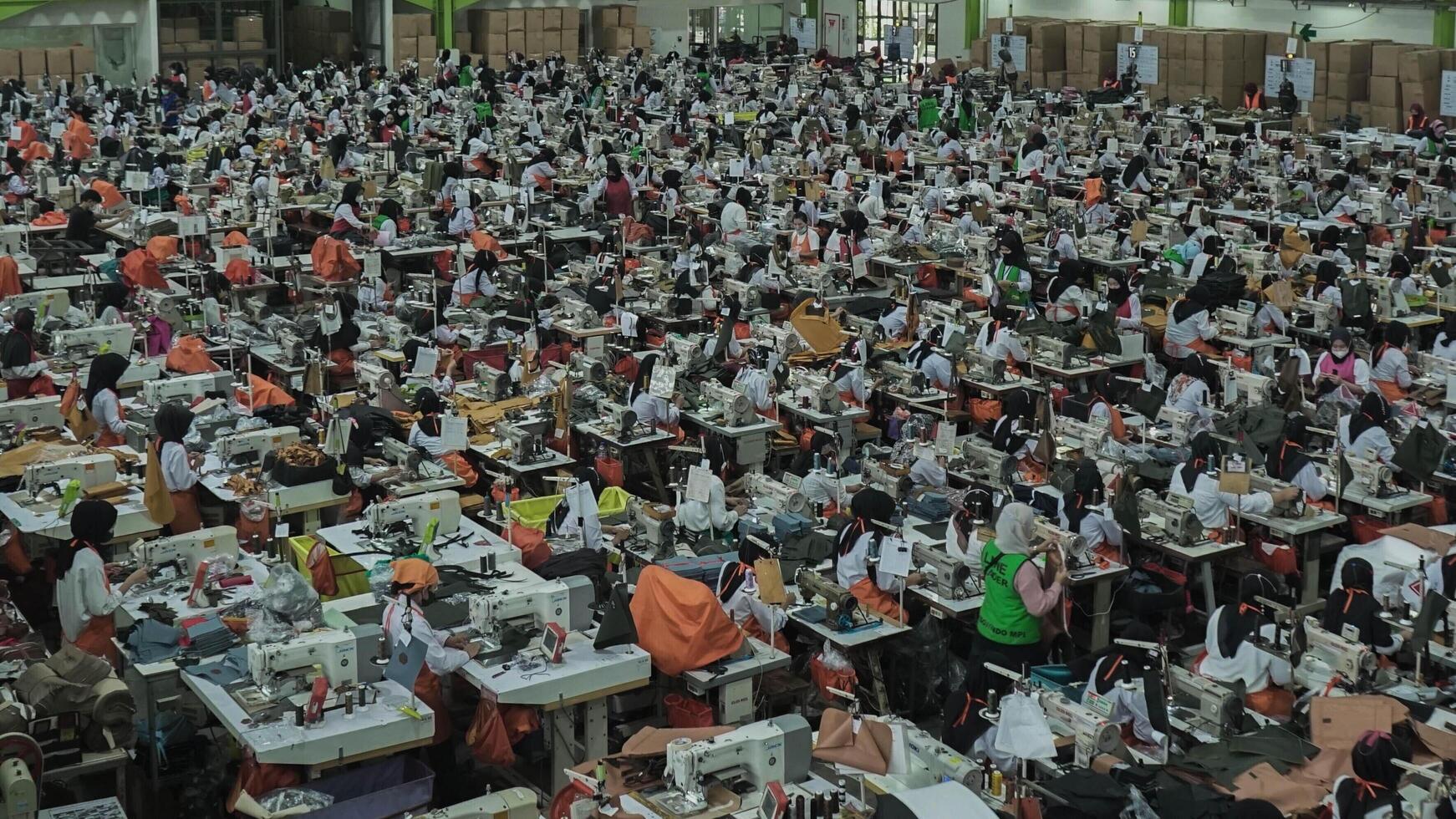Asian textile sewing factory with many workers, Indonesia. photo