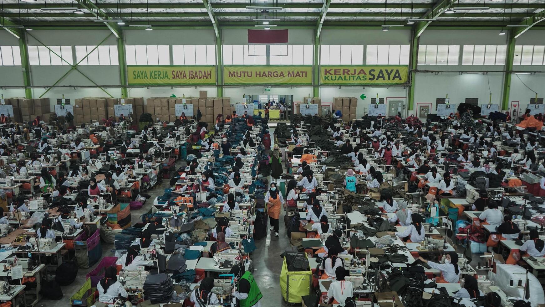 Asian textile sewing factory with many workers, Indonesia. photo