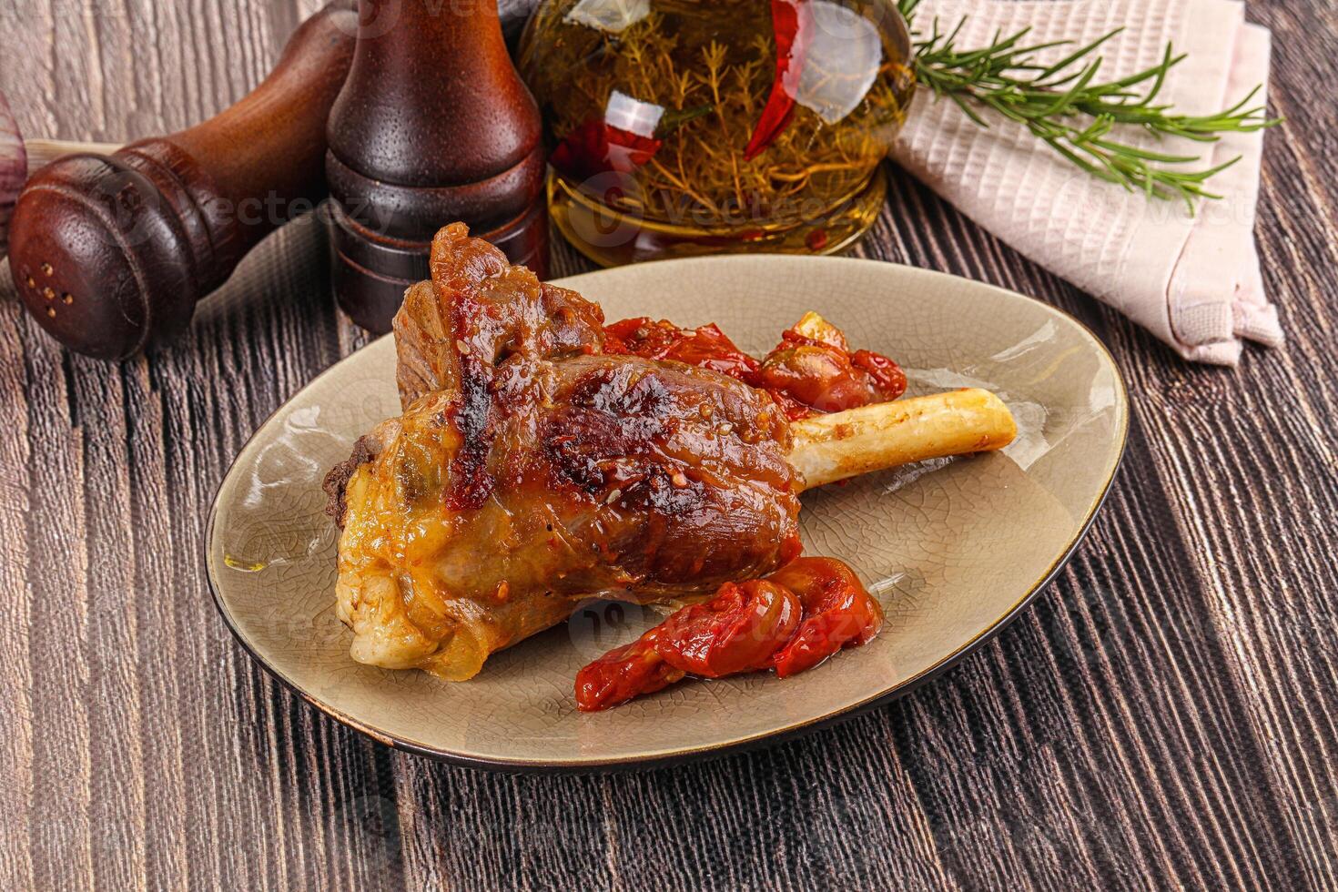 Baked lamb shank with vegetables photo