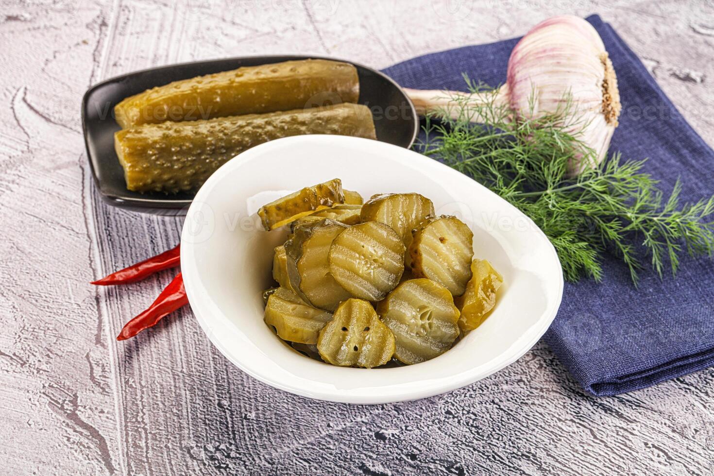 Sliced marinated cucumbers in the bowl photo