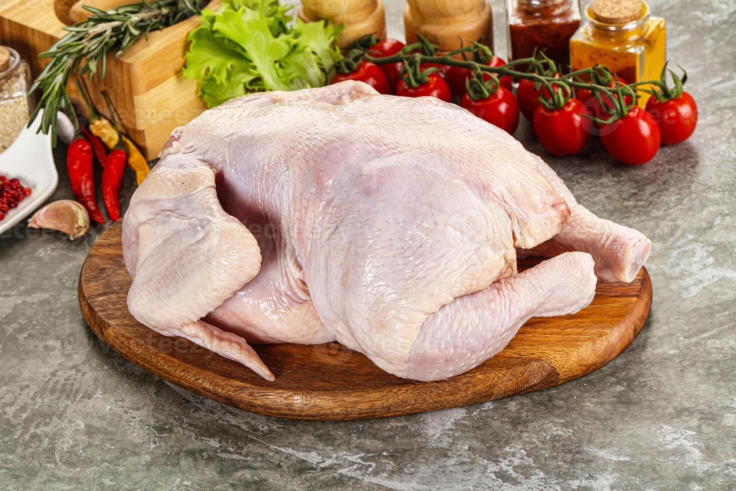 Raw whole chicken for cooking photo