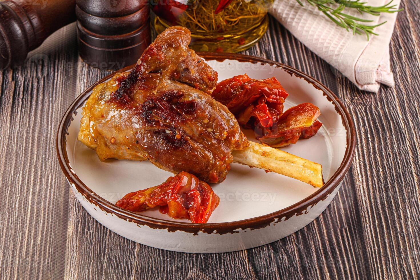 Baked lamb shank with vegetables photo