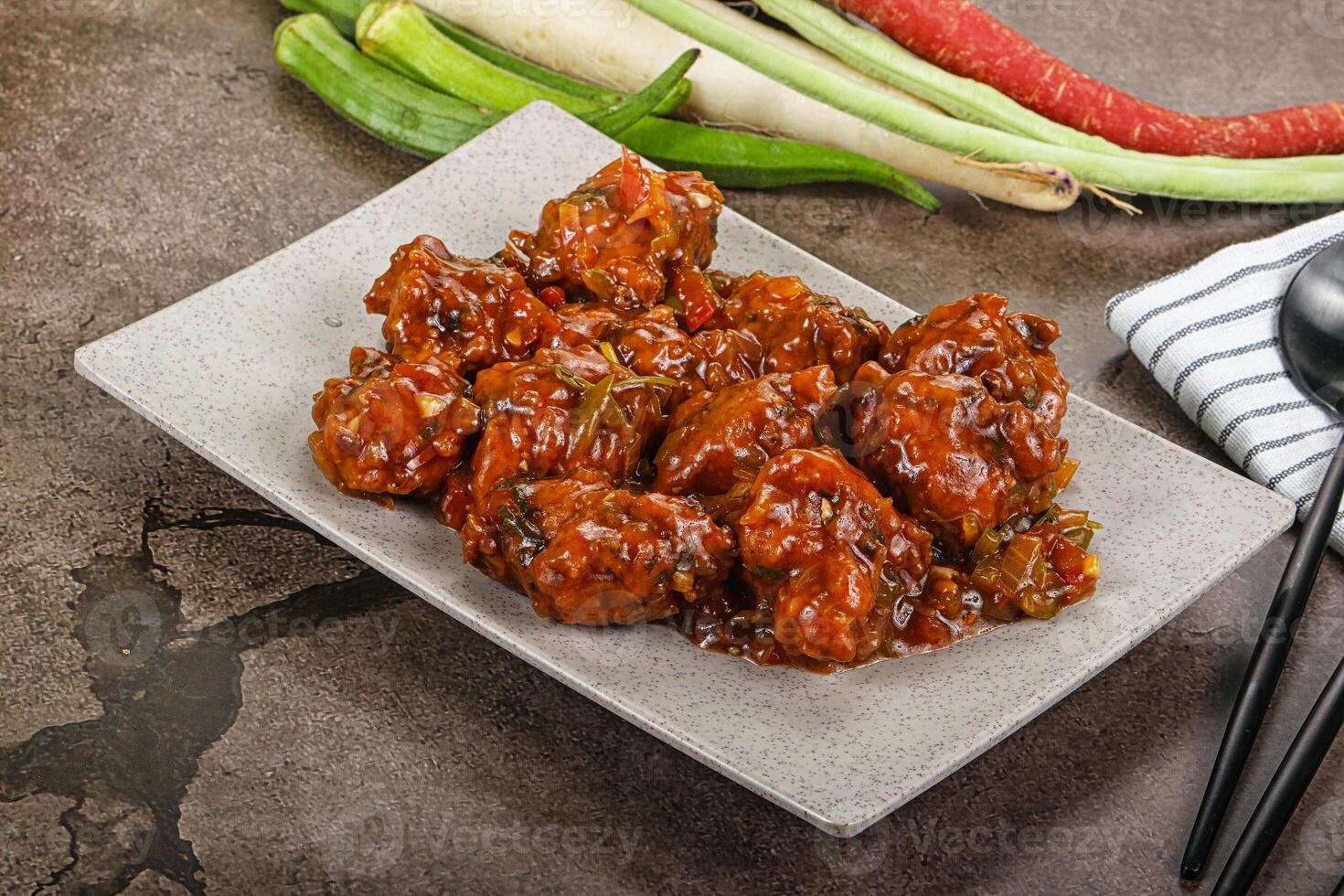 Manchurian chicken with sauce and spices photo
