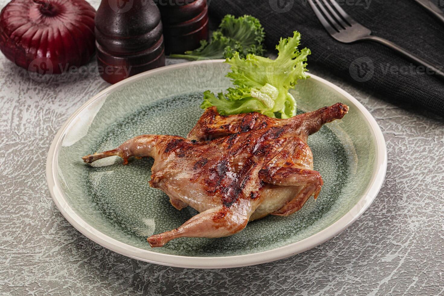 Grilled quail in the plate photo