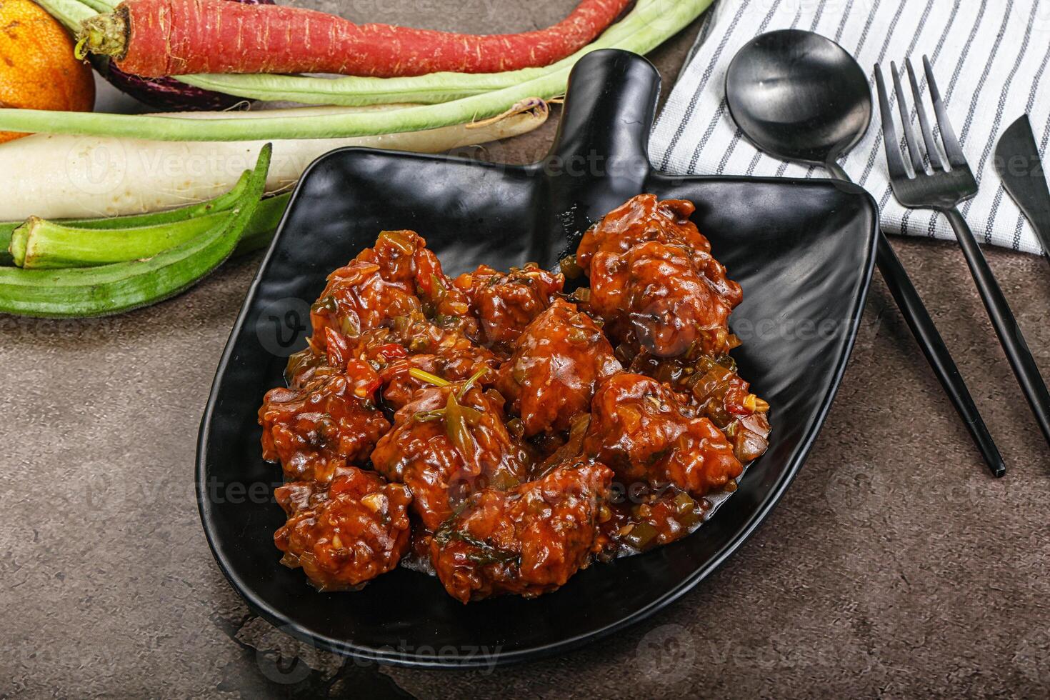Manchurian chicken with sauce and spices photo