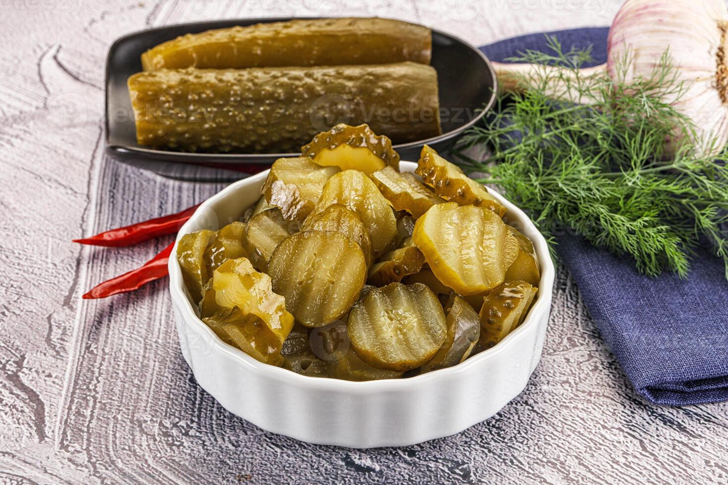 Sliced marinated cucumbers in the bowl photo