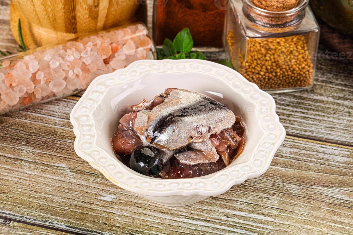 Canned anchovy with oil in the bowl photo
