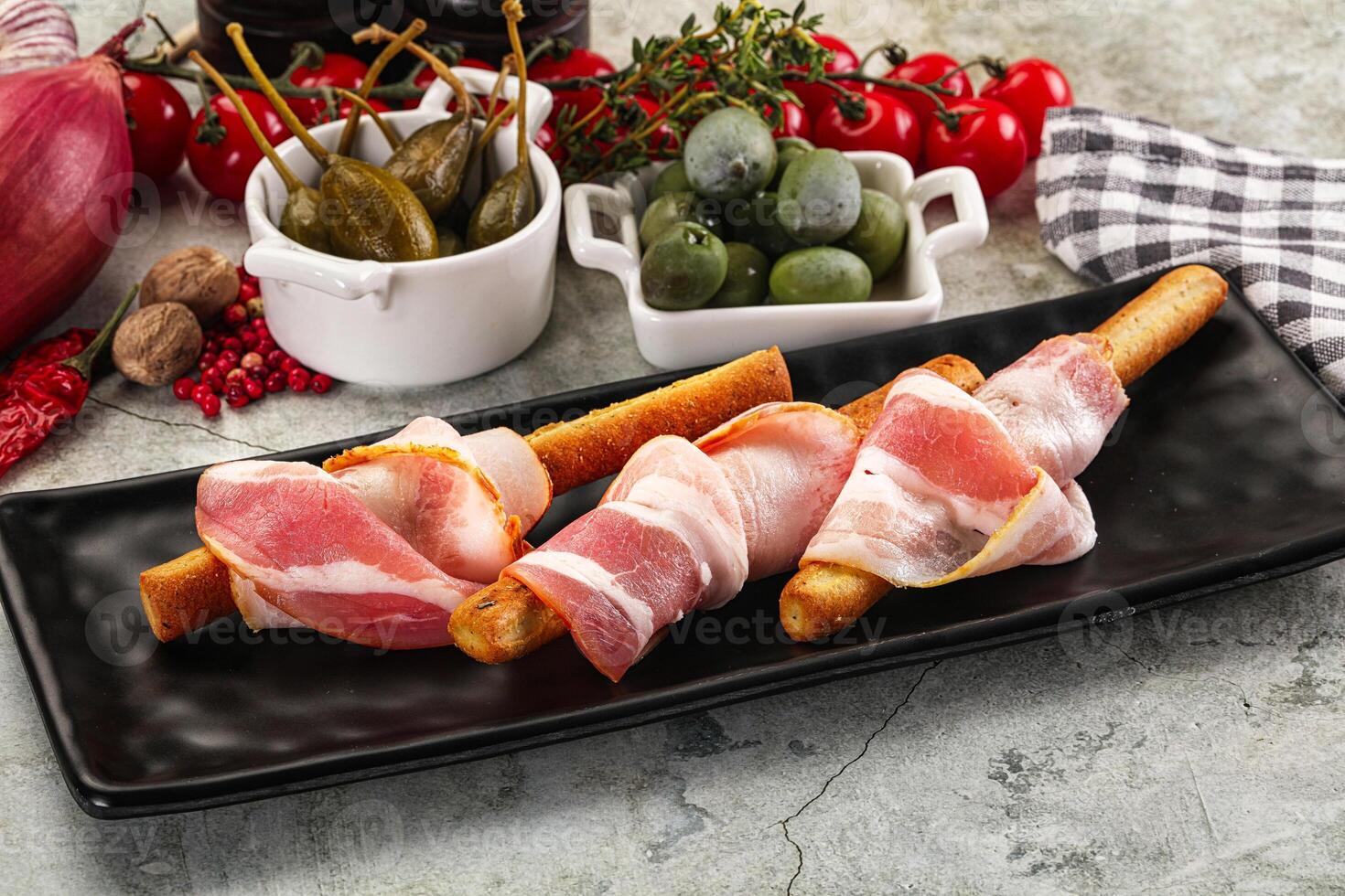 Antipasti - Grissini with pork bacon photo
