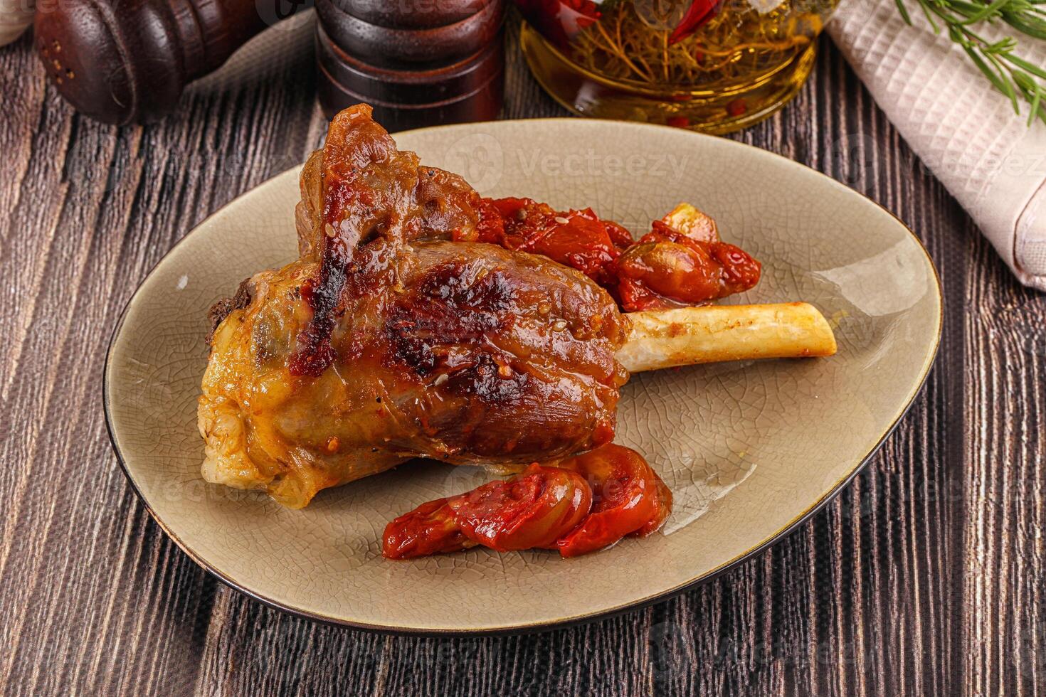 Baked lamb shank with vegetables photo