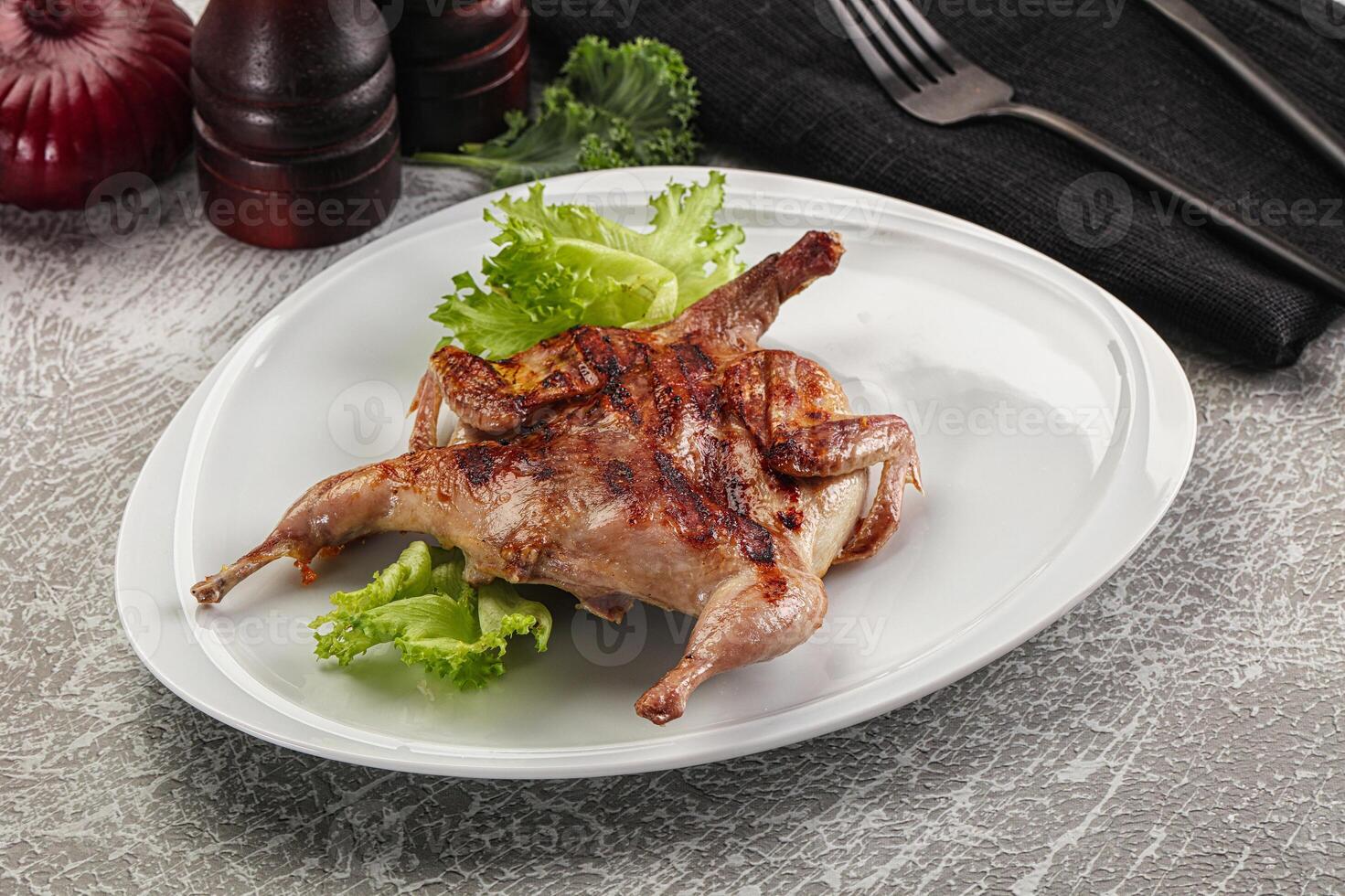 Grilled quail in the plate photo