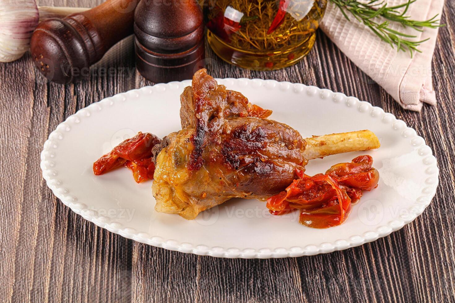 Baked lamb shank with vegetables photo