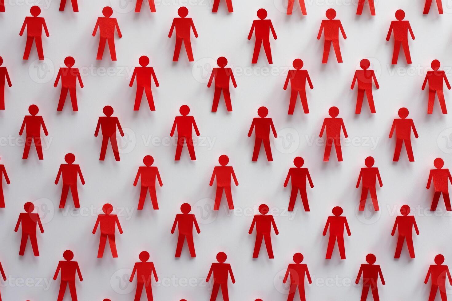 Pattern of red paper cutout people evenly spaced on a white background photo
