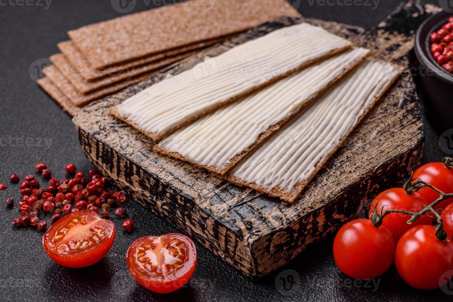 Rectangular whole grain crisp bread with cream cheese photo